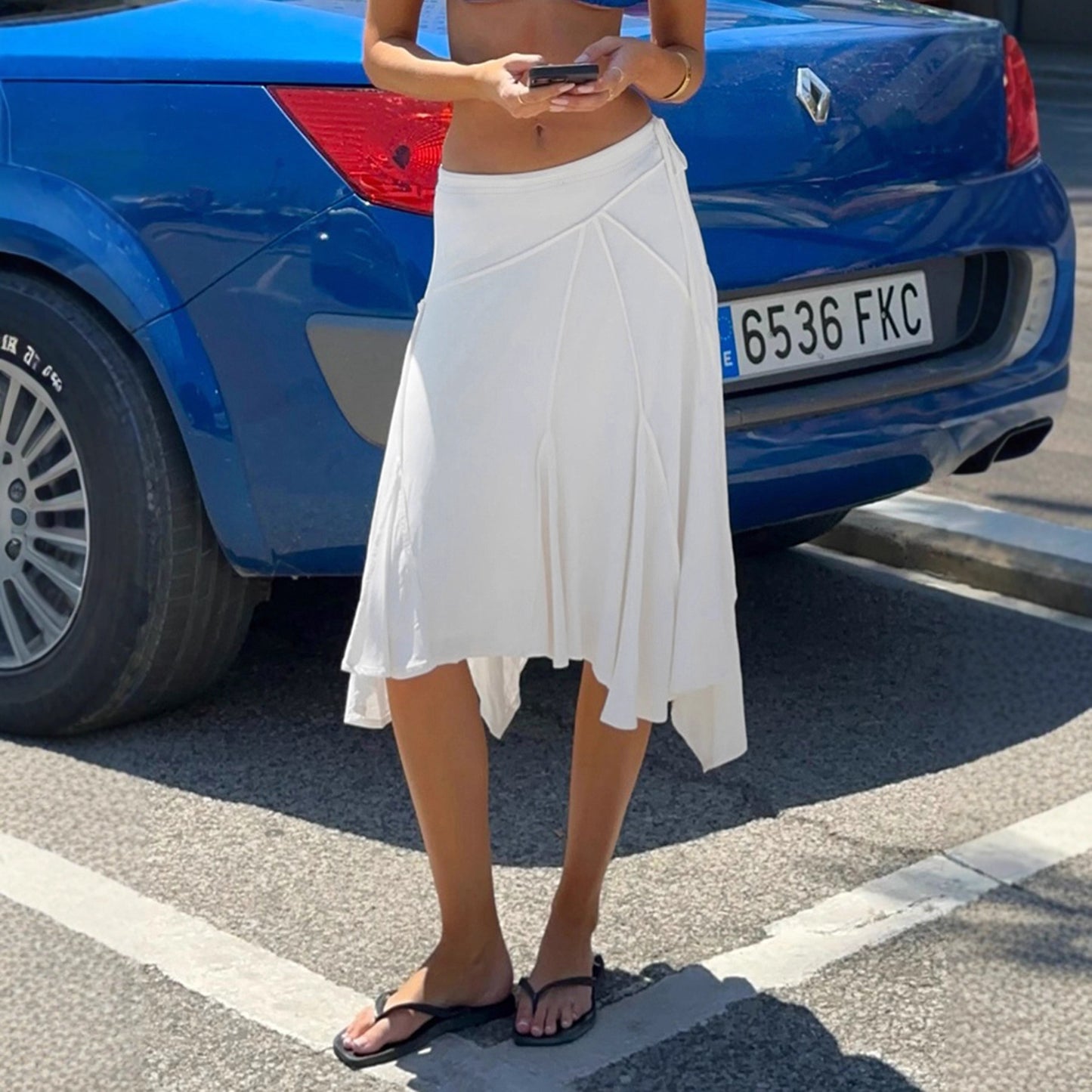 Holiday style light and familiar temperament irregular skirt European and American fashion white simple side strap Spice Girl medium and long skirt