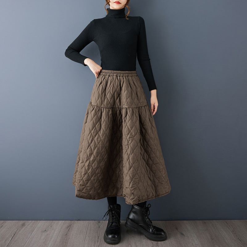 The real shot will be in the autumn and winter of 2025. The new cotton-added warm and thin solid-color A-shaped skirt women's clothing.
